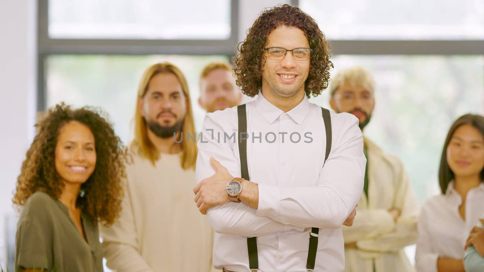 Man standing in front of his work team in the office