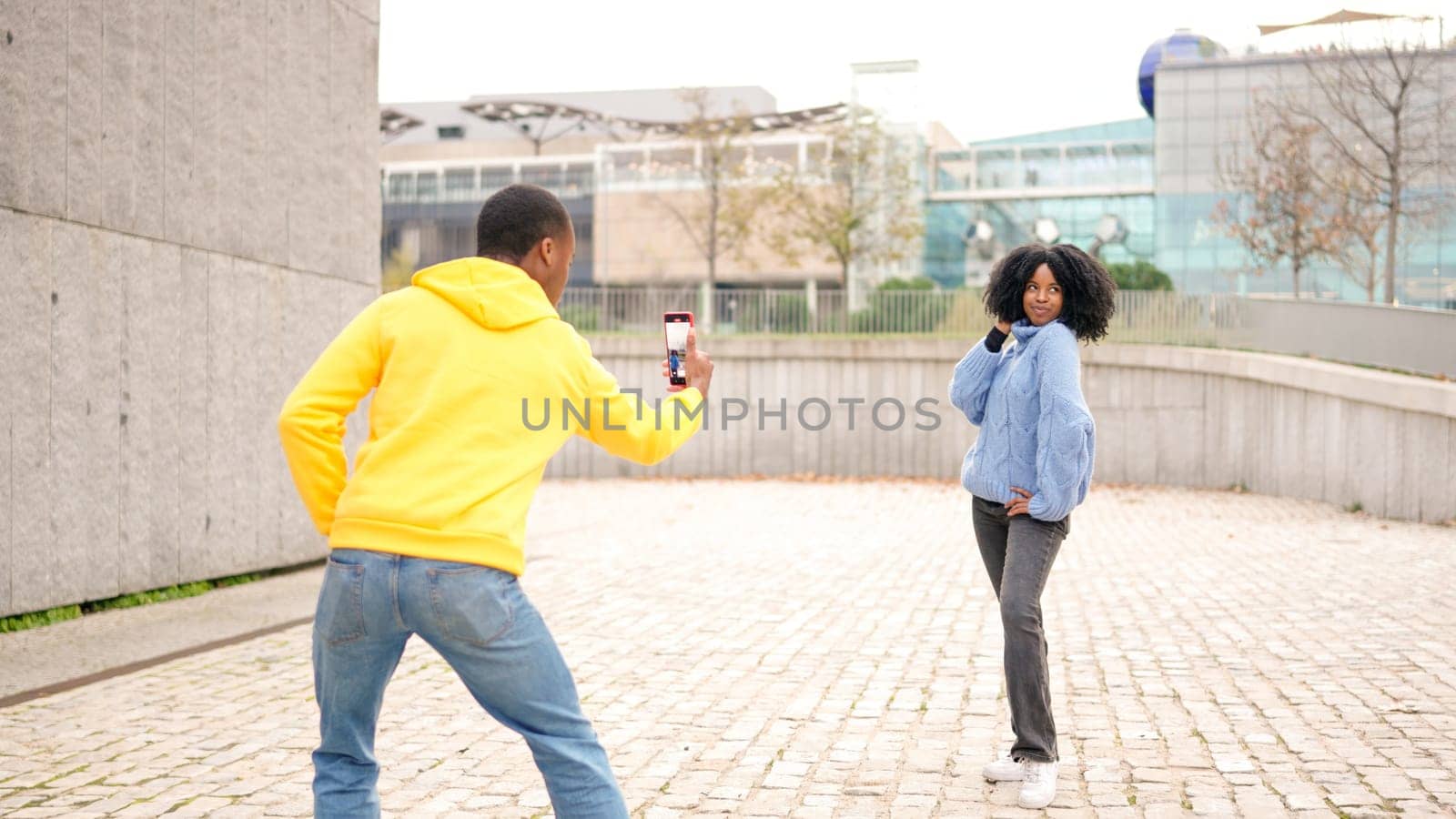 African woman posing while her couple taking photos of her by ivanmoreno