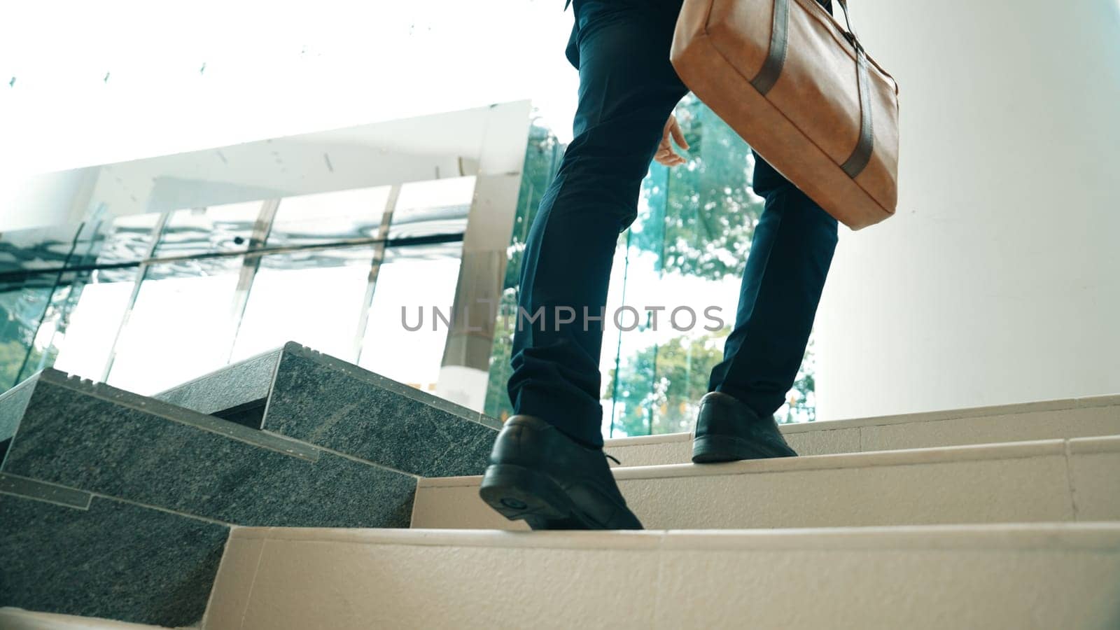 Closeup of business man leg go up the stairs. Successful man going up the stairs while explore a new thing. Represented traveling, getting a promotion, finding a new job, increasing skill. Exultant.