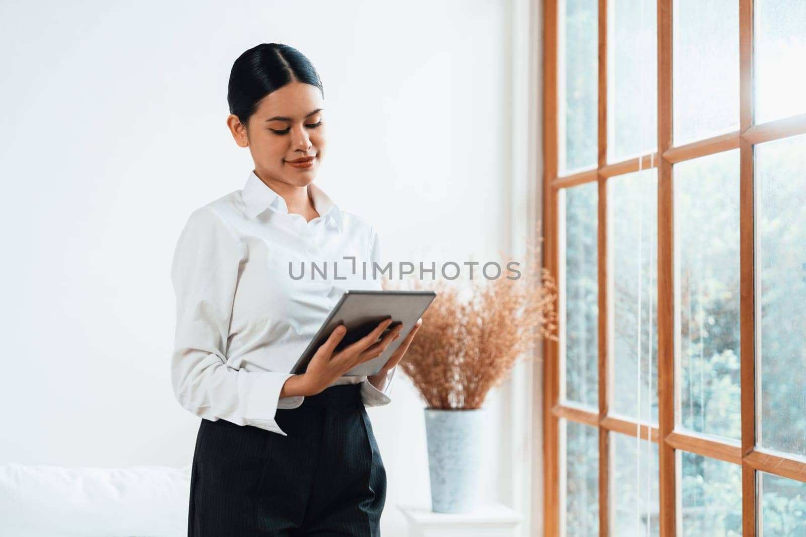 Psychologist woman in clinic office professional portrait with friendly smile feeling inviting for patient to visit the psychologist. The experienced and confident psychologist is uttermost specialist