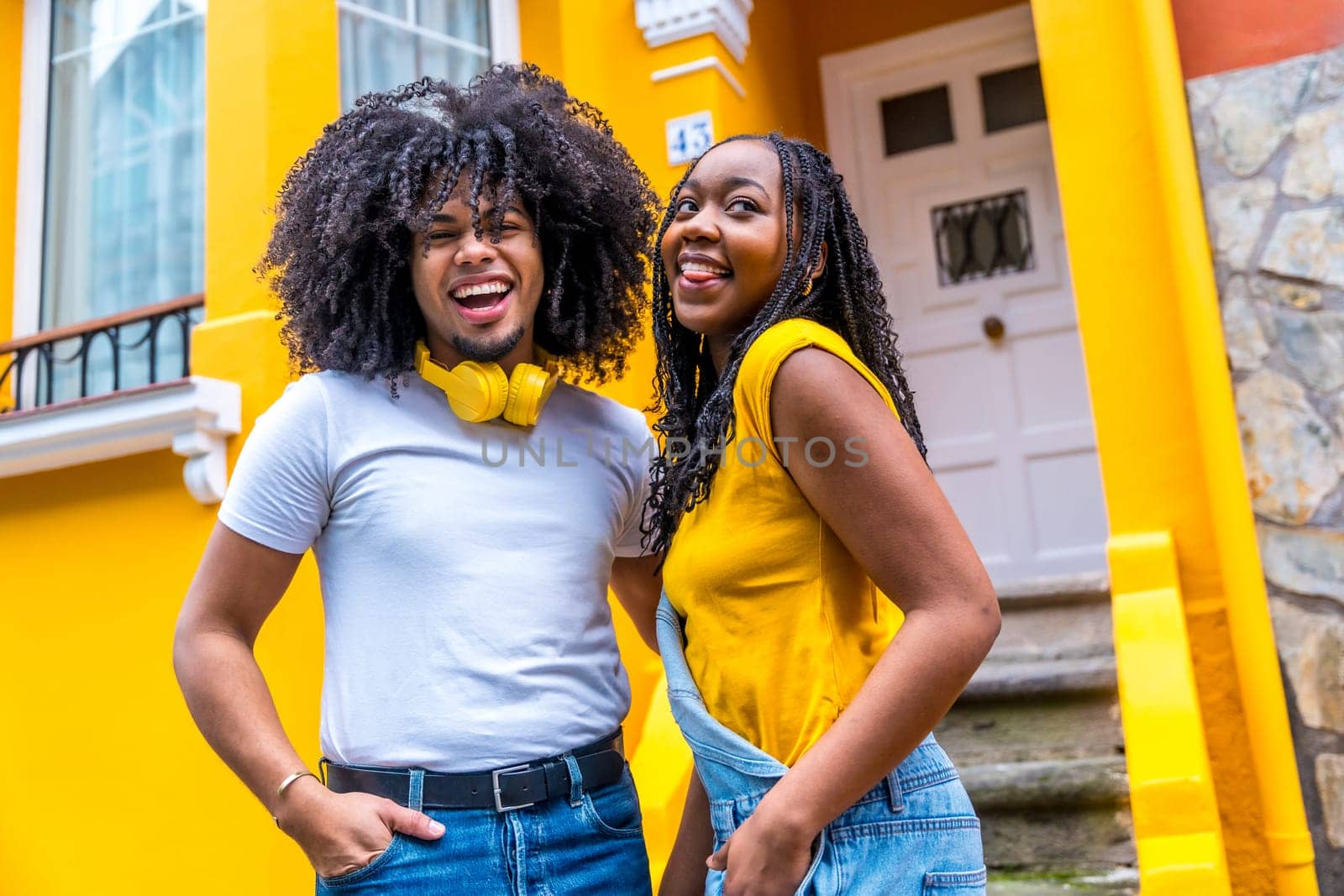 Portrait of a happy urban african couple smiling outdoors by Huizi