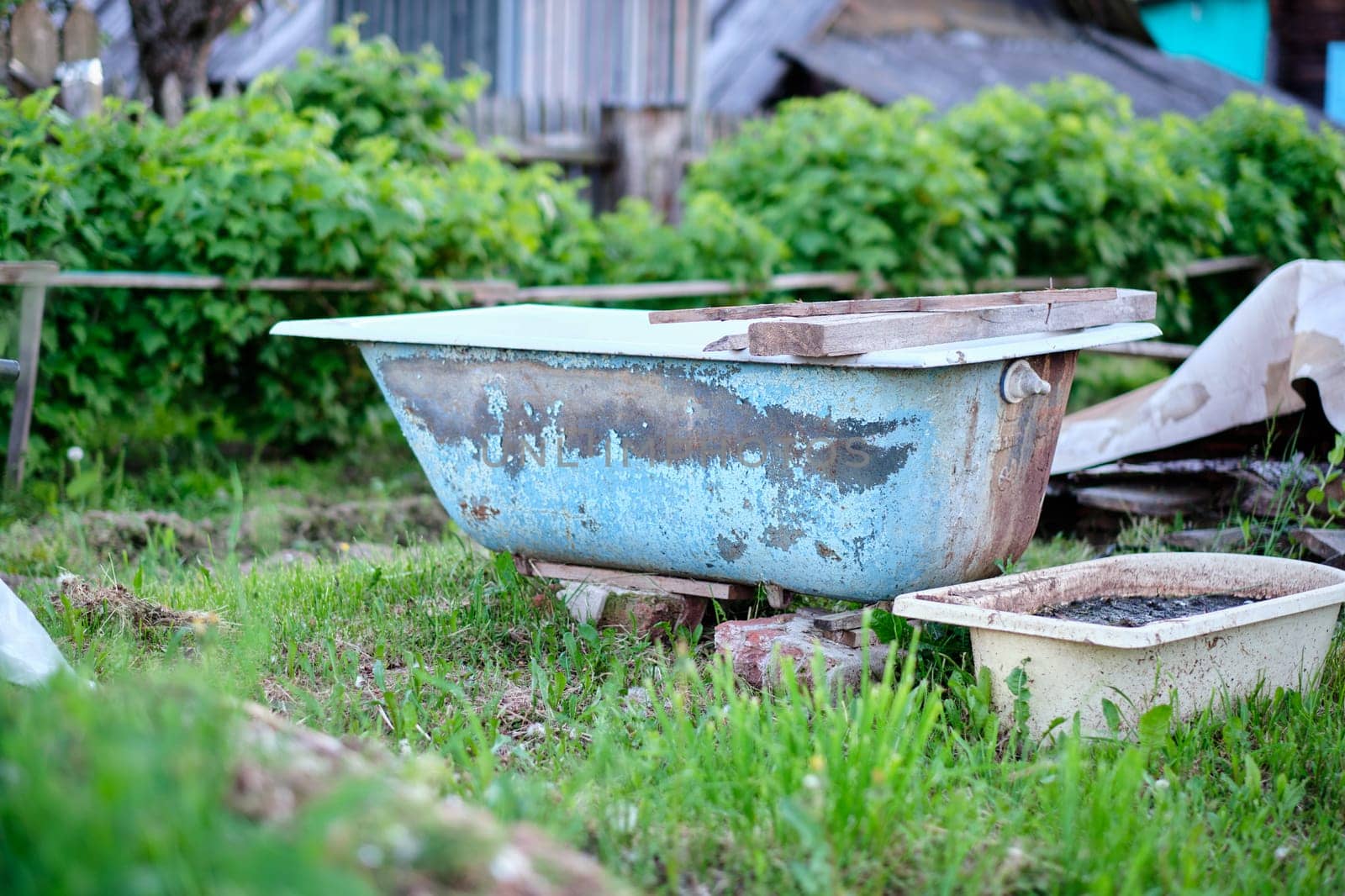 An old bathing tub is placed in the garden as a memento of a past life