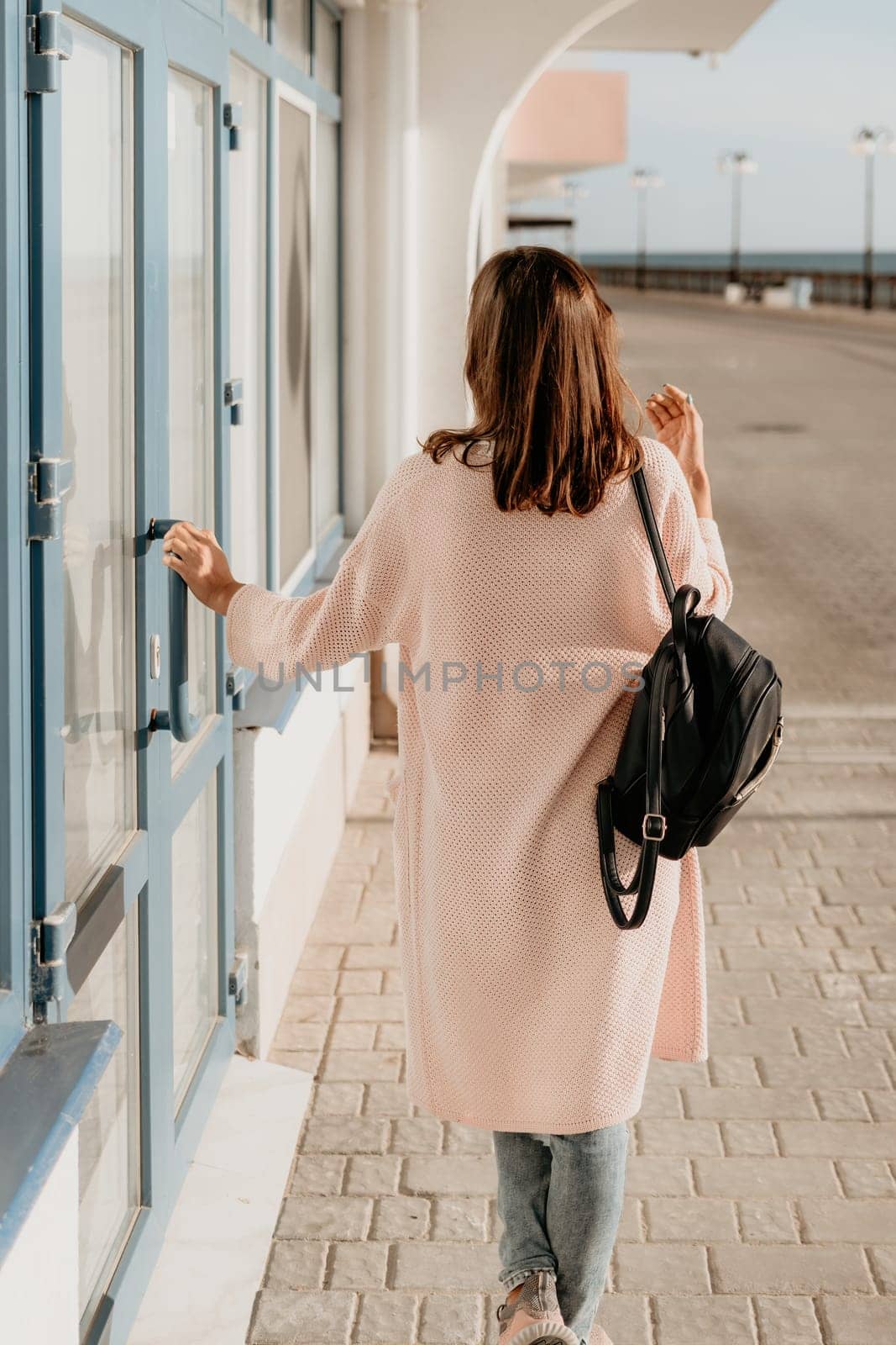 Woman summer travel sea. Happy tourist enjoy taking picture outdoors for memories. Carefree woman traveler posing on beach at sea on sunset, sharing travel adventure journey. Holiday vacation concept. by panophotograph