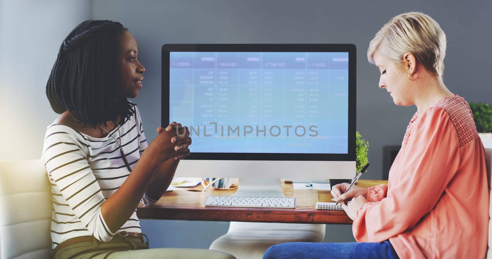 Business women, communication and feedback by computer screen in office, diversity and talking or writing on accounting. Workplace, productivity or finance team by desktop or collaboration on project.