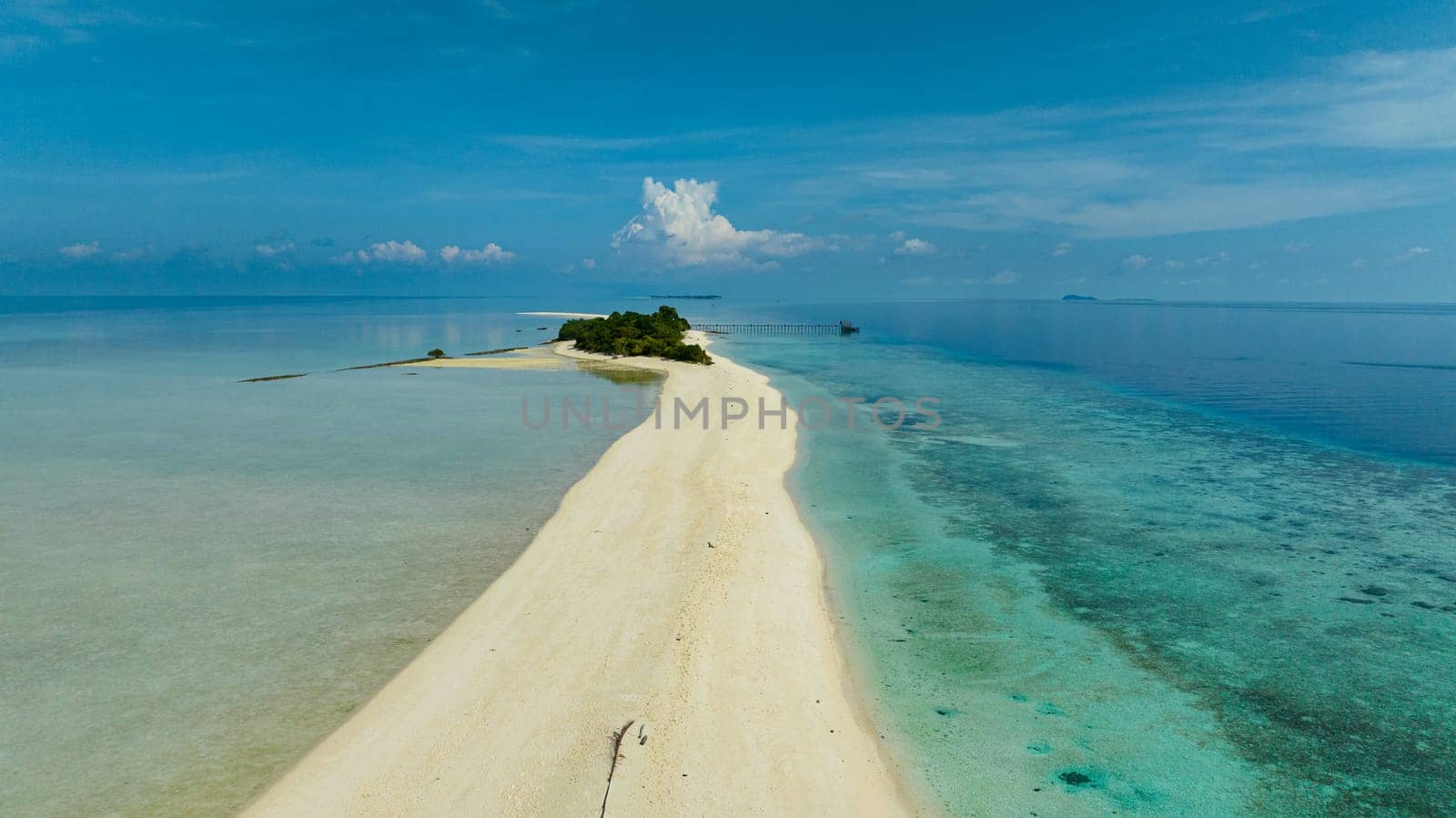 Sandy tropical island with a beautiful beach surrounded by a coral reef.Timba Timba islet. Tun Sakaran Marine Park. Borneo, Sabah, Malaysia.