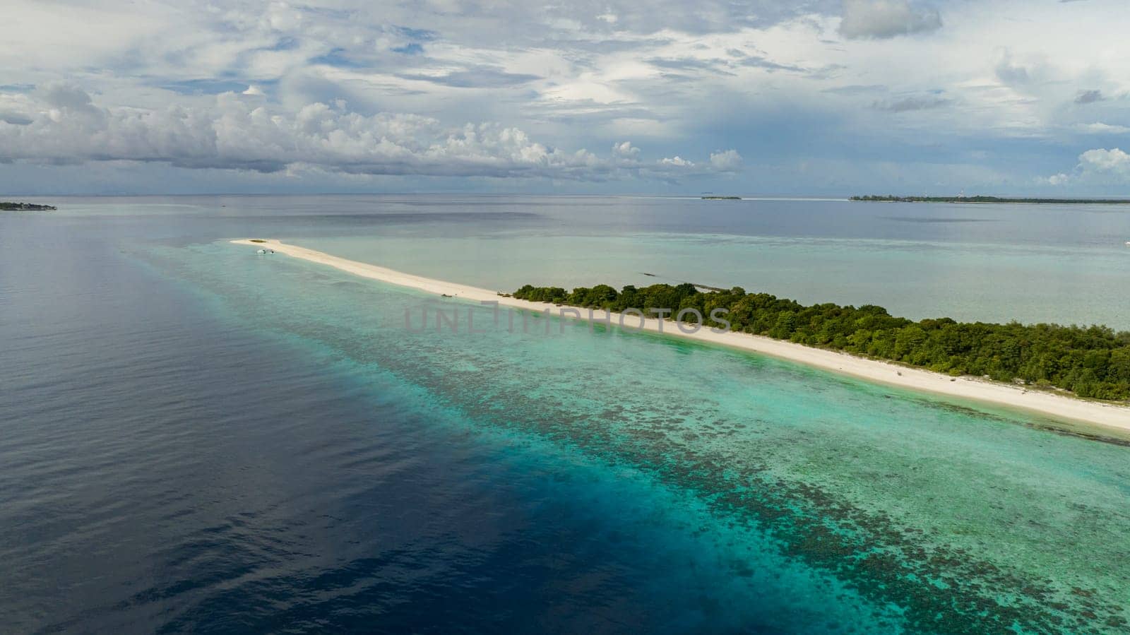 Tropical sandy beach and blue sea. Timba Timba islet. Tun Sakaran Marine Park. Borneo, Sabah, Malaysia.