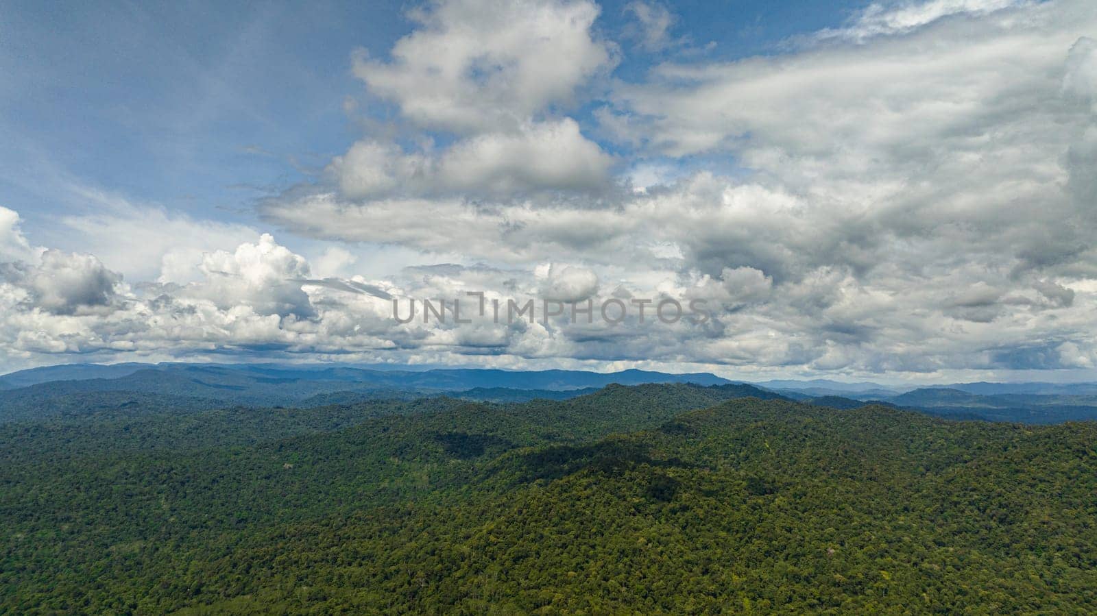 Aerial drone of tropical mountain range and mountain slopes with rainforest. Borneo, Malaysia.