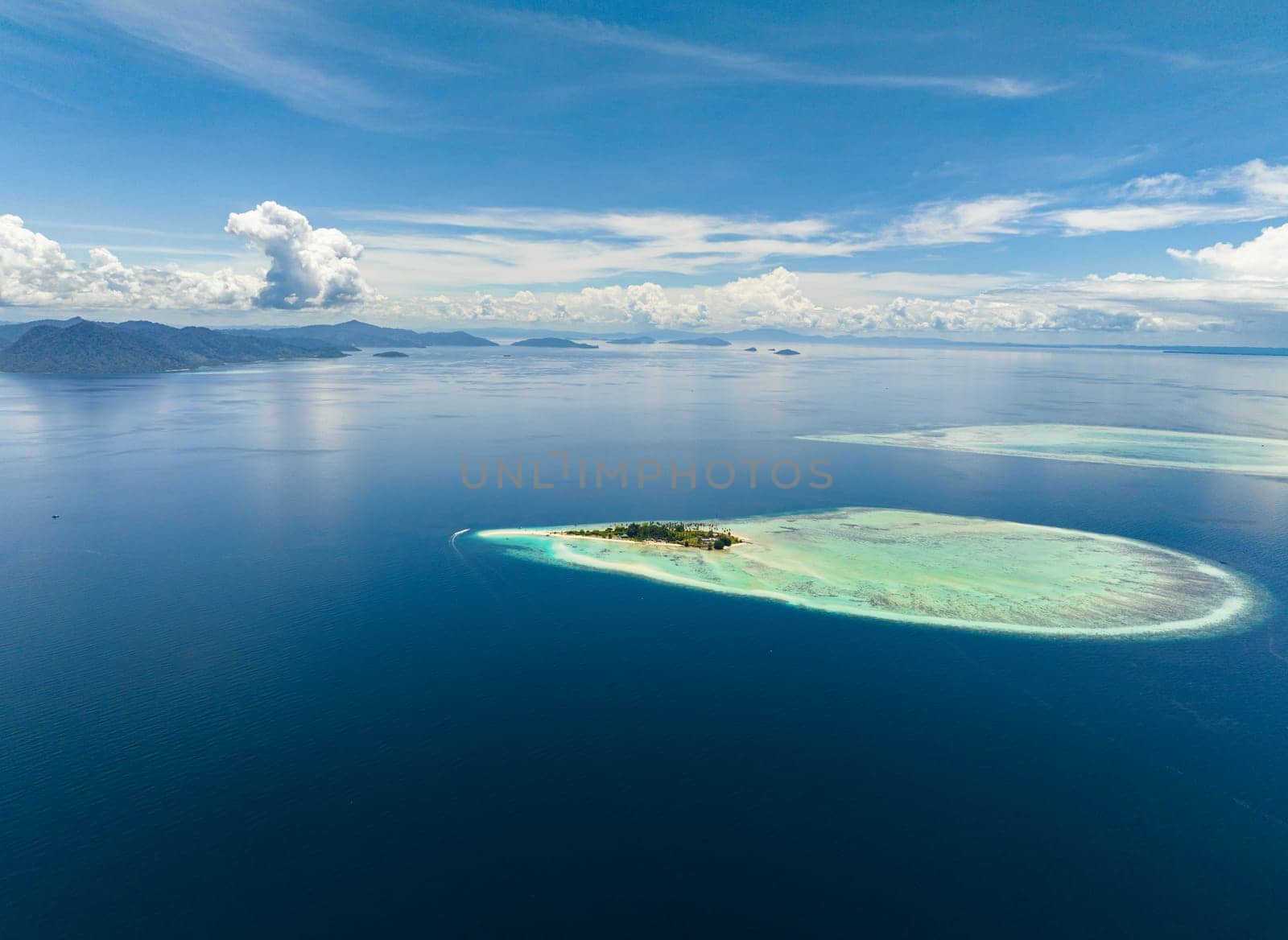 Aerial view of tropical island and coral atolls in tropic. Tun Sakaran Marine Park. Borneo, Sabah, Malaysia.