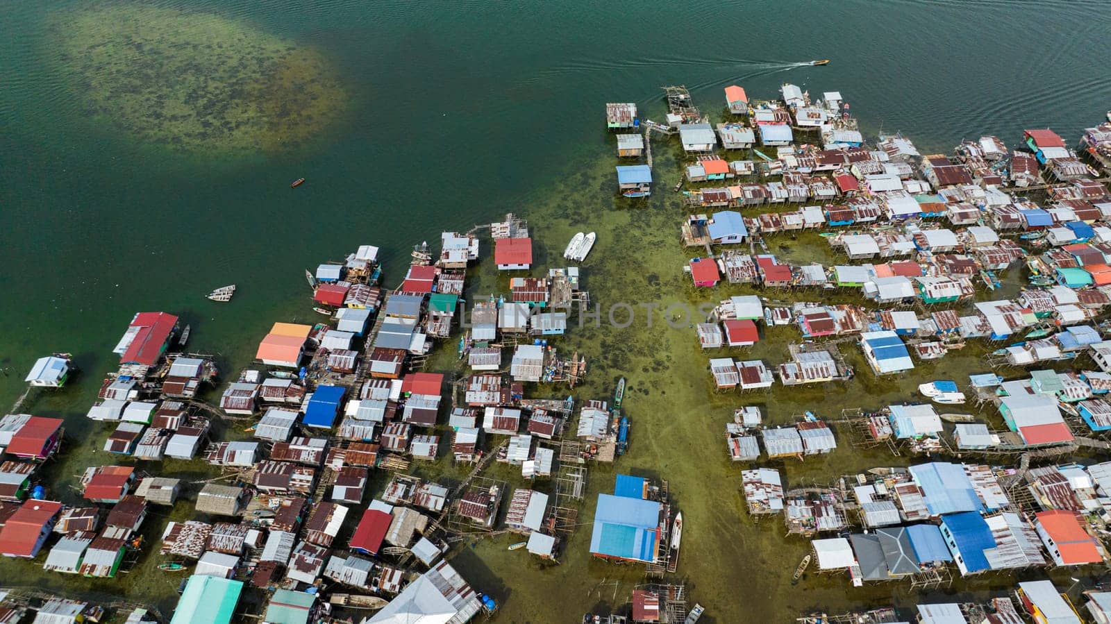 Fishing village located on the water in the sea view from above. Houses of the poor. Borneo,Semporna. Sabah, Malaysia.