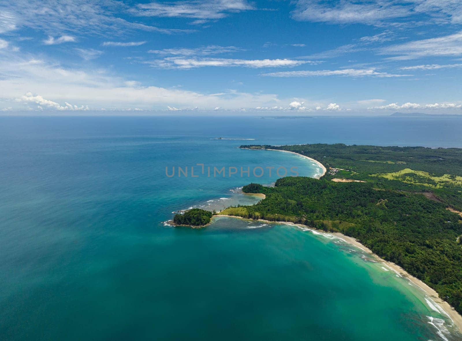 Tropical beach with crystal clear water in the tropics view from above. Borneo, Malaysia.