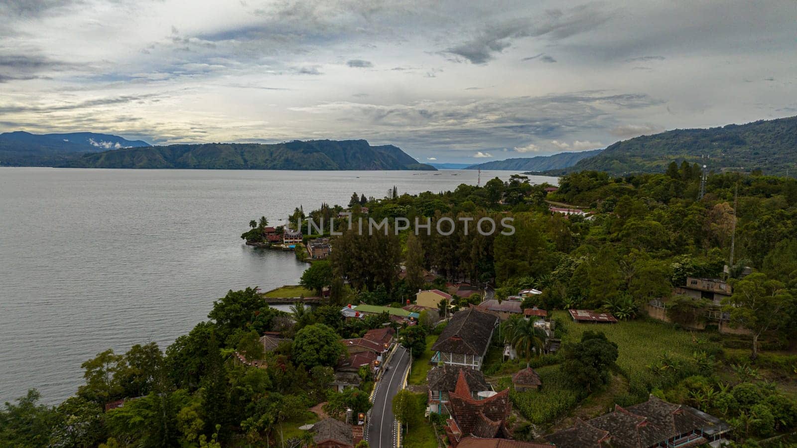 Lake Toba and Samosir Island. Tuk Tuk traditional village and tourist destination. Sumatra, Indonesia. Tropical landscape.