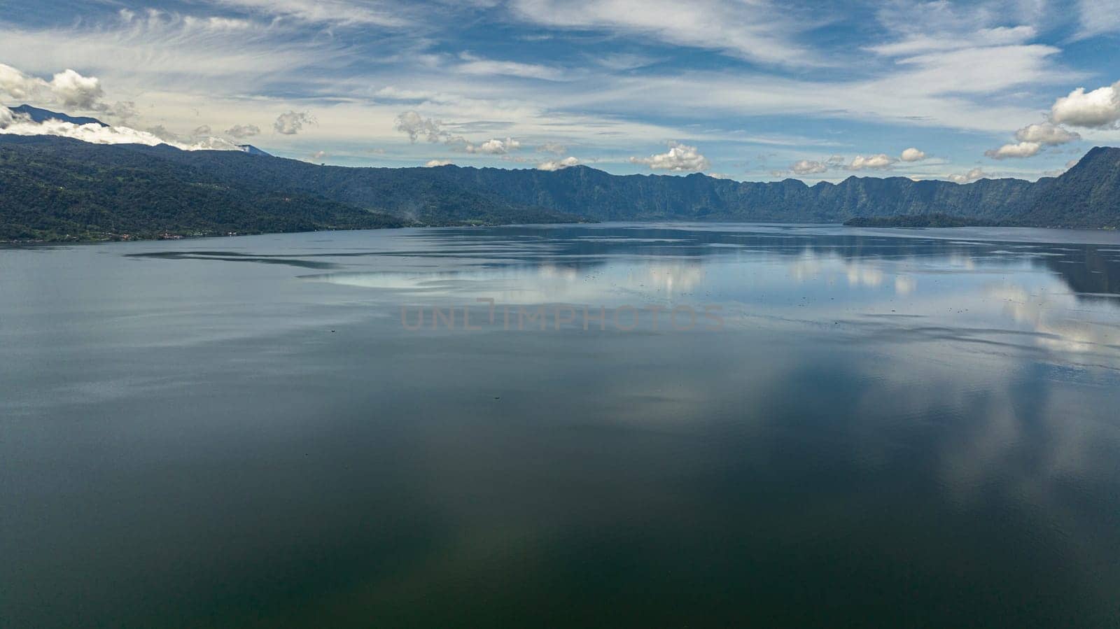 Beautiful lake Maninjau in mountains. Tropical landscape with mountains and a lake. Sumatra, Indonesia.