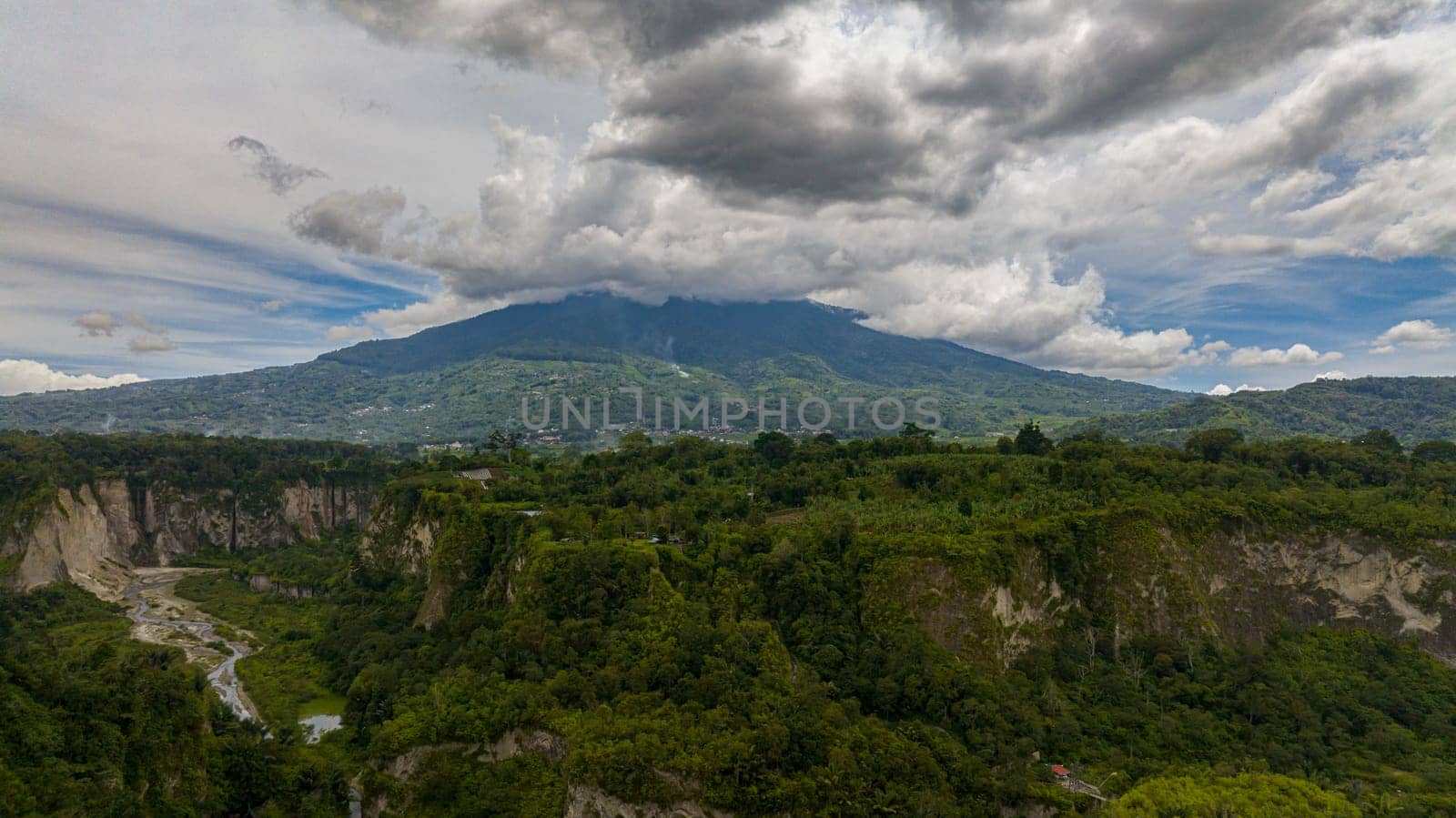 Aerial view of canyon and valley with rainforest and Mount Singgalang. Ngarai Sianok. Bukittinggi, Sumatra, Indonesia.