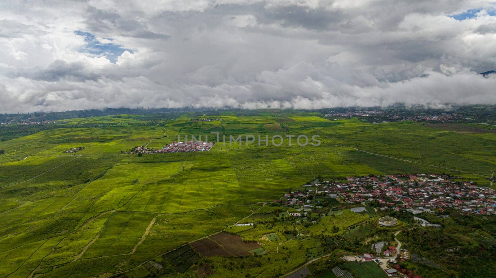 Top view of valley with tea plantations and farmland in the highlands. Kayu Aro, Sumatra, Indonesia.