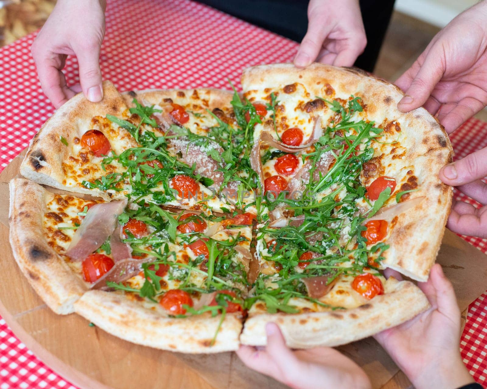 Pizza with ham and vegetables on wooden table . High quality photo