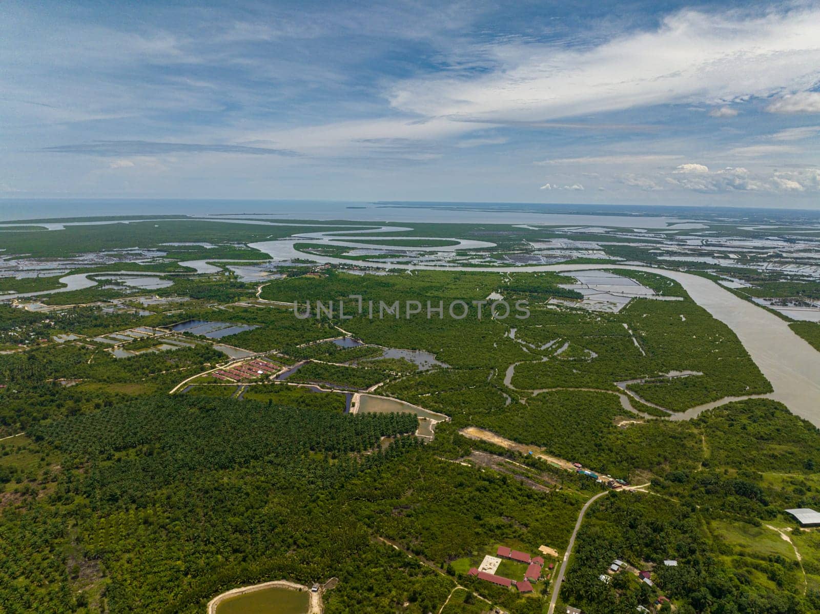 Aerial drone of countryside with farmland and rice fields. Sumatra. Indonesia.