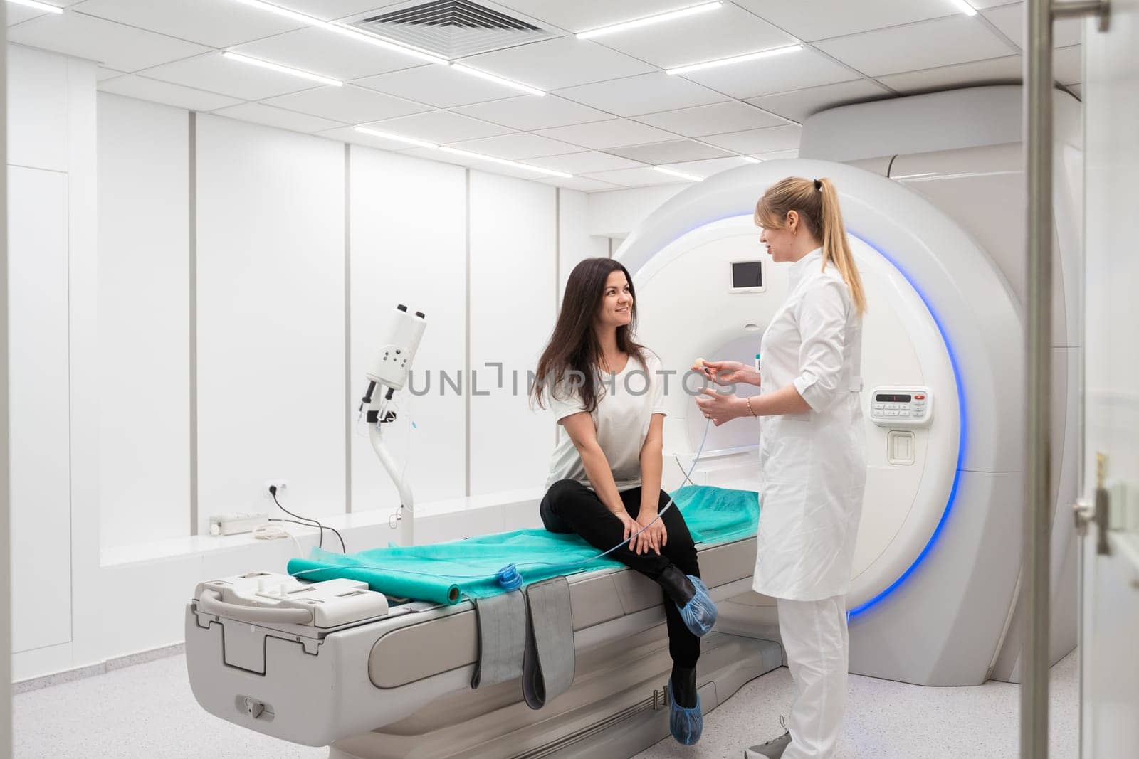 Medical CT or MRI Scan with a patient in the modern hospital laboratory. Interior of radiography department. Technologically advanced equipment in white room. Magnetic resonance diagnostics machine by Andelov13
