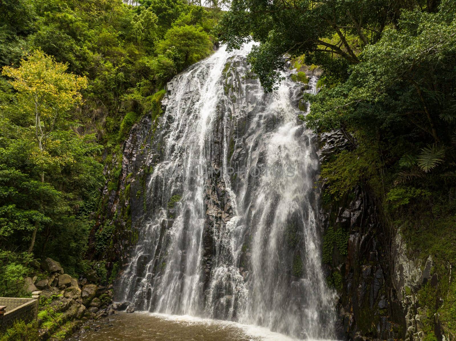 Waterfall in the mountains among the green forest. Efrata falls. Sumatra, Indonesia.