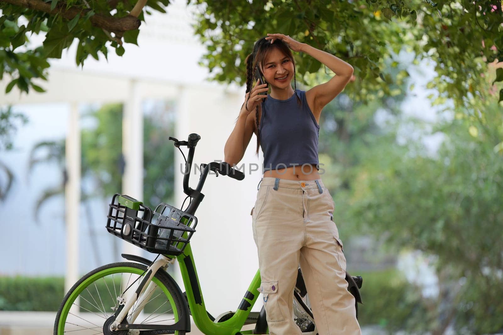 Happy Asian young woman ride bicycle in park, street city her smiling using bike of transportation, ECO friendly, People eco lifestyle concept.
