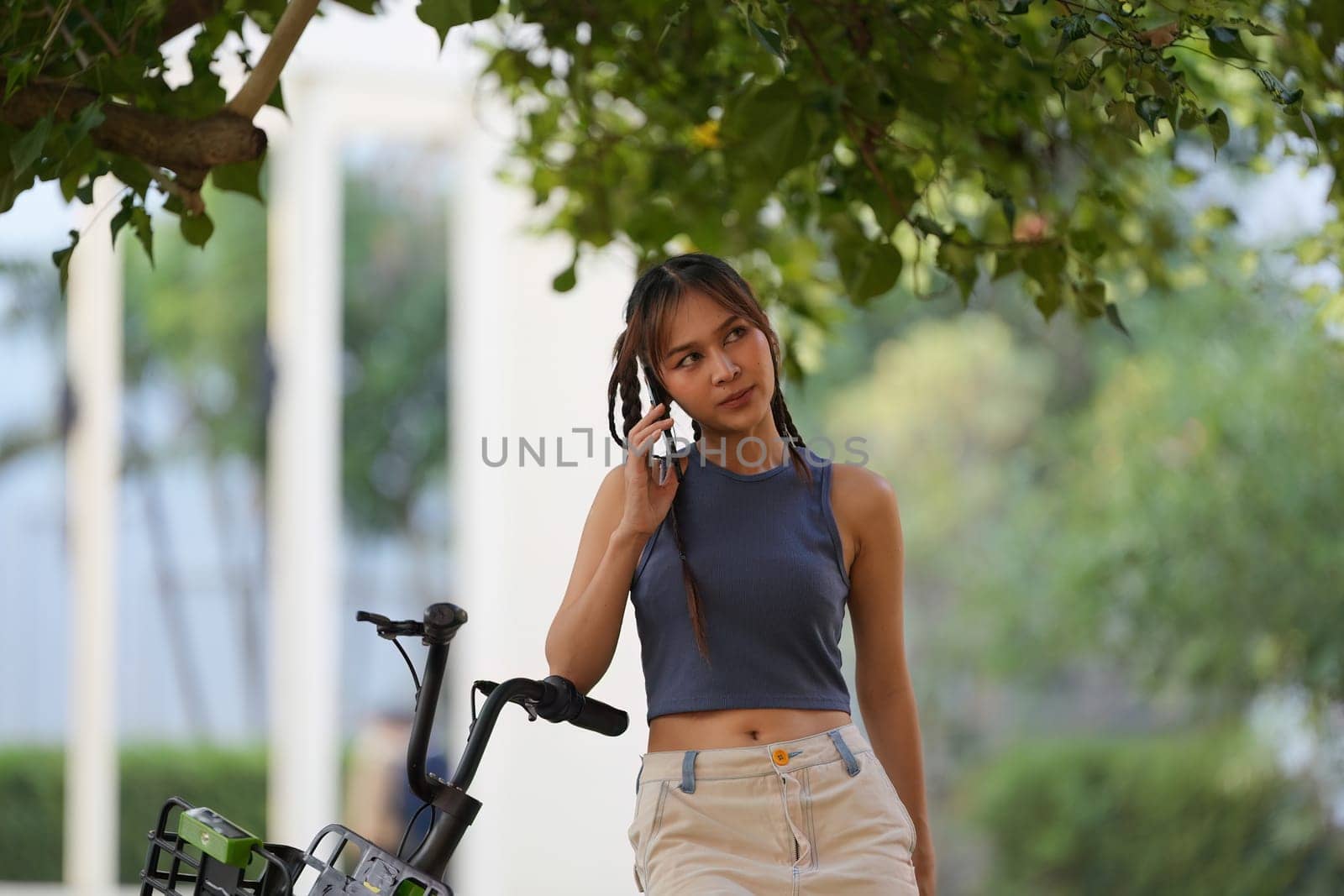 Happy Asian young woman ride bicycle in park, street city her smiling using bike of transportation, ECO friendly, People lifestyle concept by itchaznong