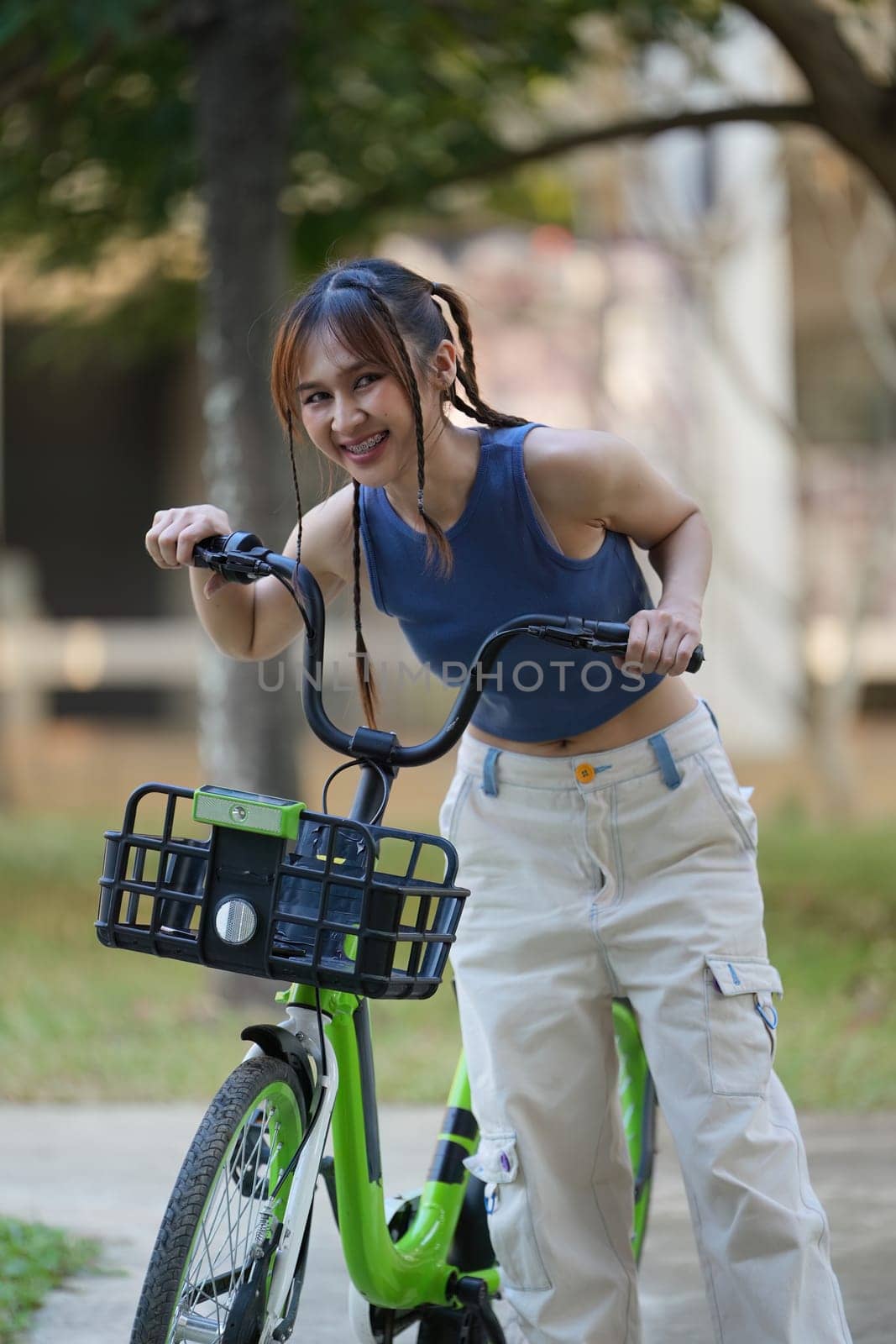 Happy Asian young woman ride bicycle in park, street city her smiling using bike of transportation, ECO friendly, , People eco lifestyle concept by itchaznong
