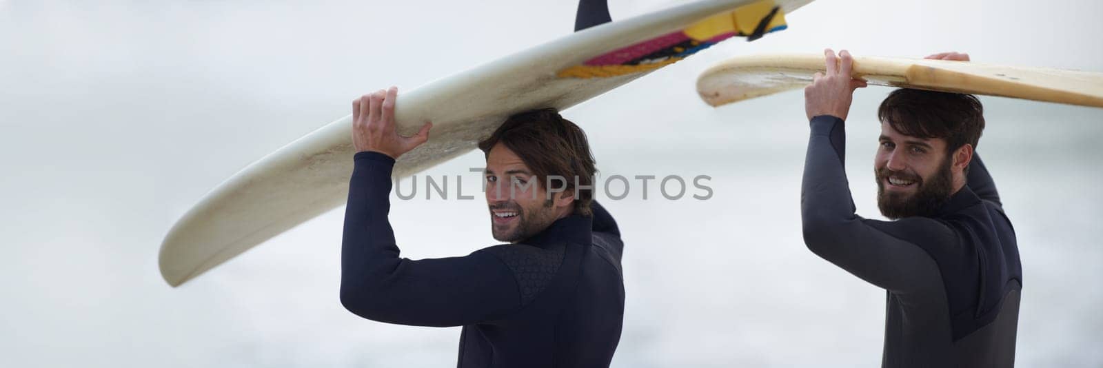 Man, friends and banner of surfer on beach for fitness, sport or waves on shore in outdoor exercise. Portrait of male person or people with surfboard for surfing challenge or hobby by ocean in nature.