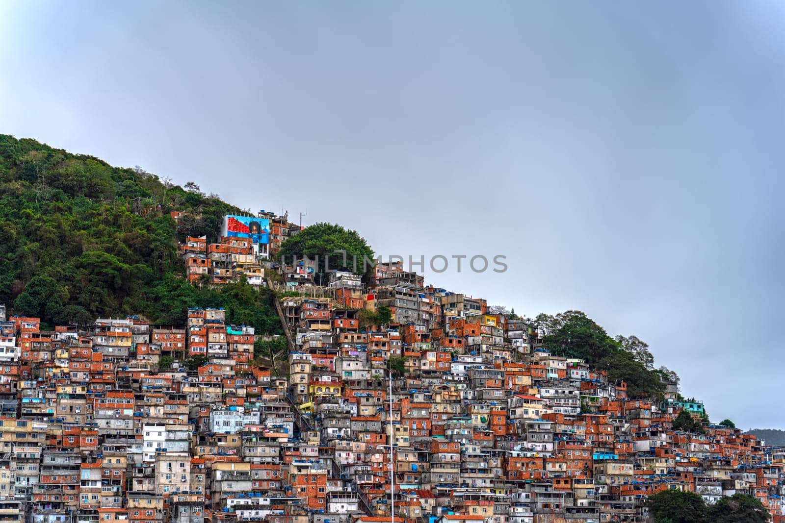 Photo depicts a colorful, crowded favela in Rio de Janeiro, symbolizing the struggle of poverty in Brazil.