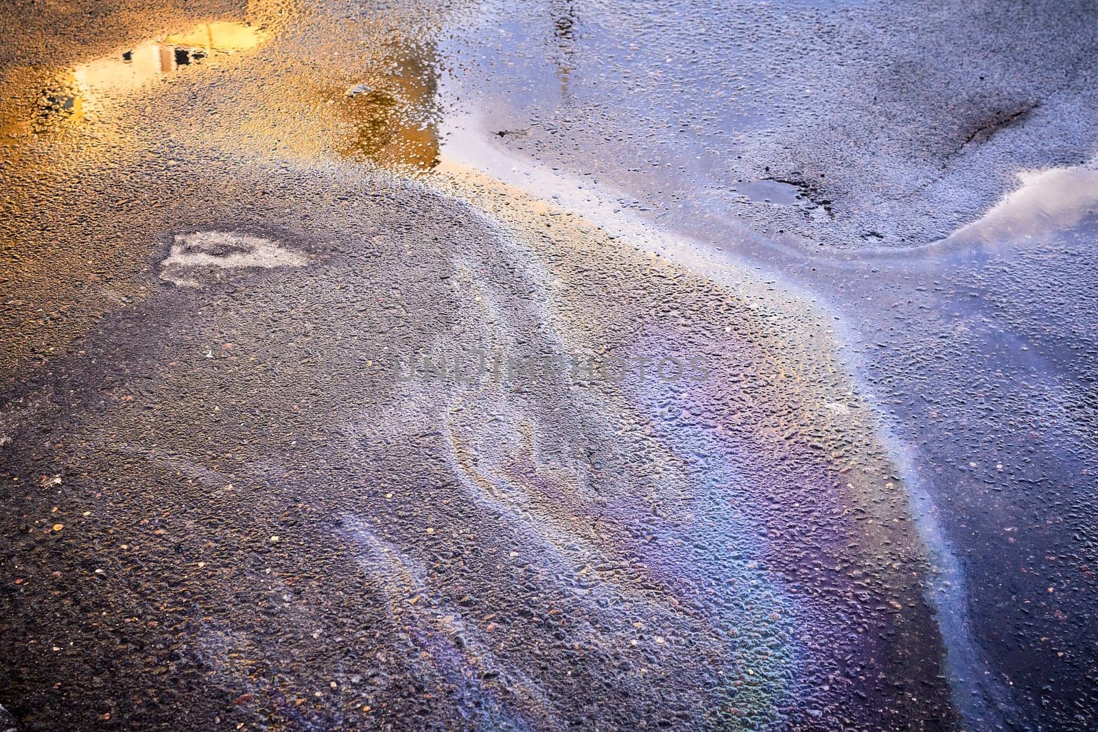 A colorful stain of engine oil on the road