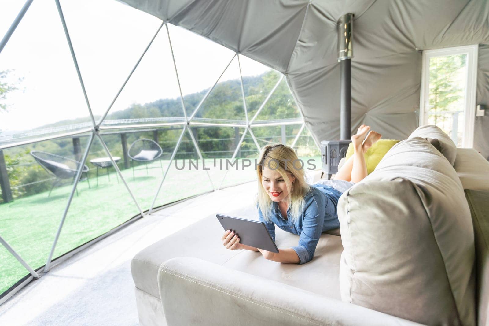 woman with tablet in dome tent.