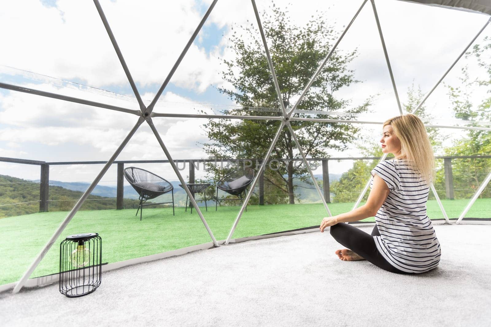 Transparent bubble tent at glamping, Lush forest around and interior. woman resting in glamping by Andelov13