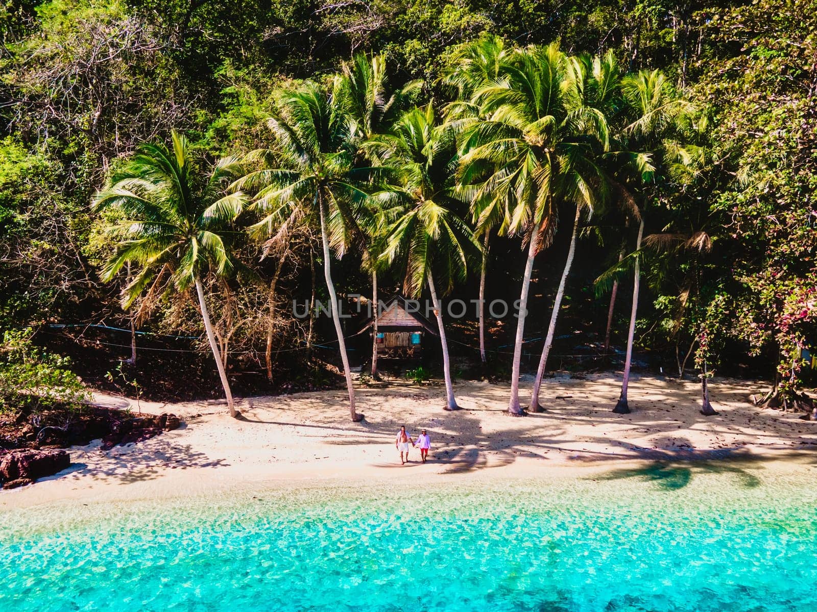 drone view at Koh Wai Island Trat Thailand is a tinny tropical Island near Koh Chang. wooden bamboo hut bungalow on the beach. a young couple of men and woman on a tropical Island in Thailand