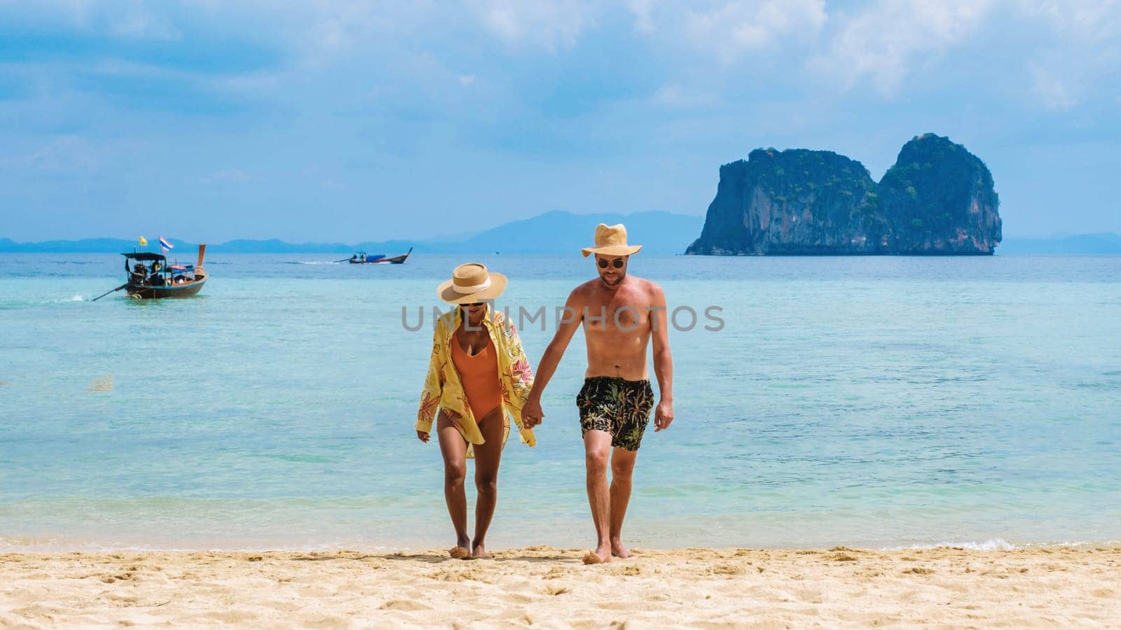 a couple of Thai woman and European men on the beach of the tropical Island Koh Ngai island Thailand by fokkebok