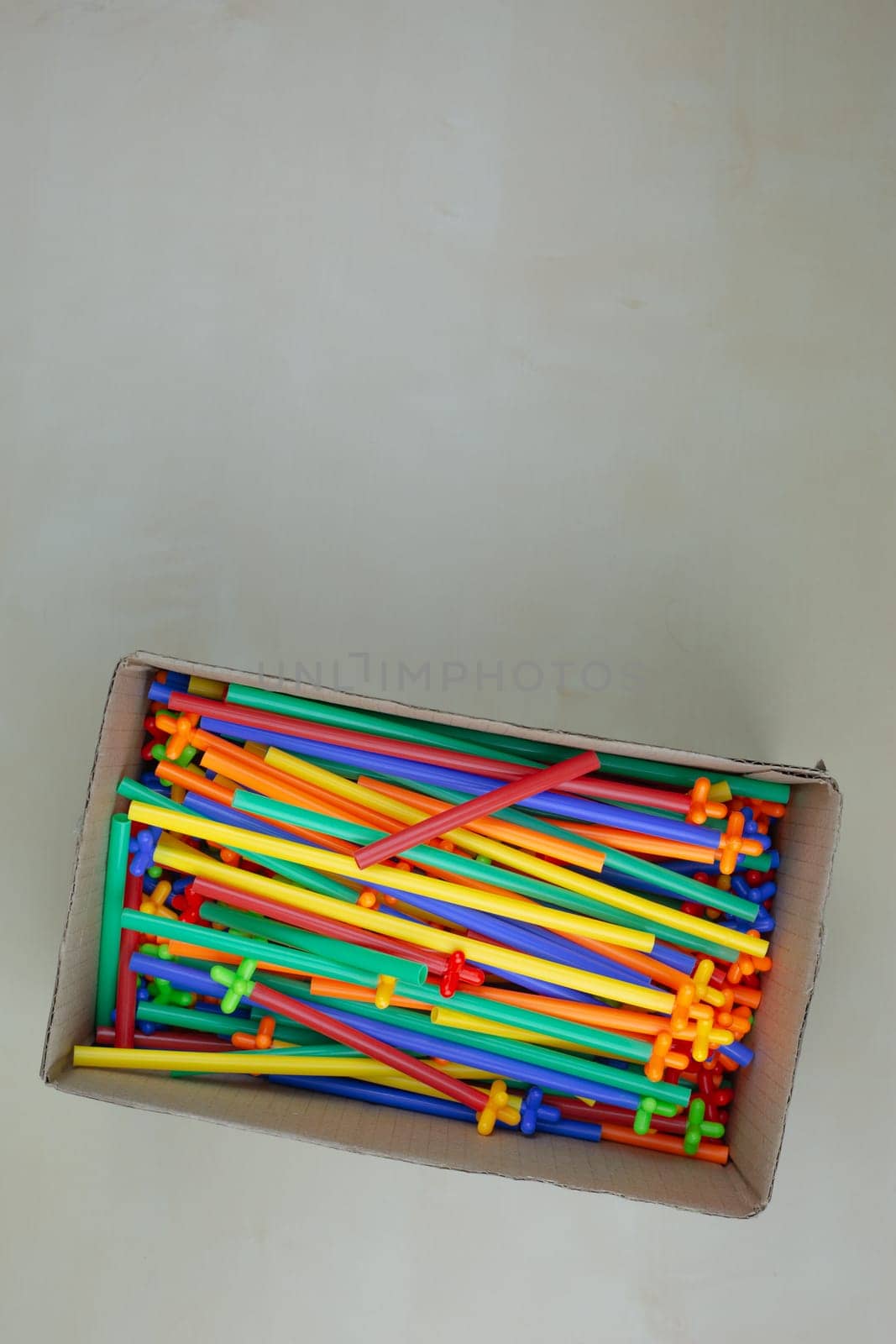 Flexible construction set made of plastic tubes with special connectors in box on the table