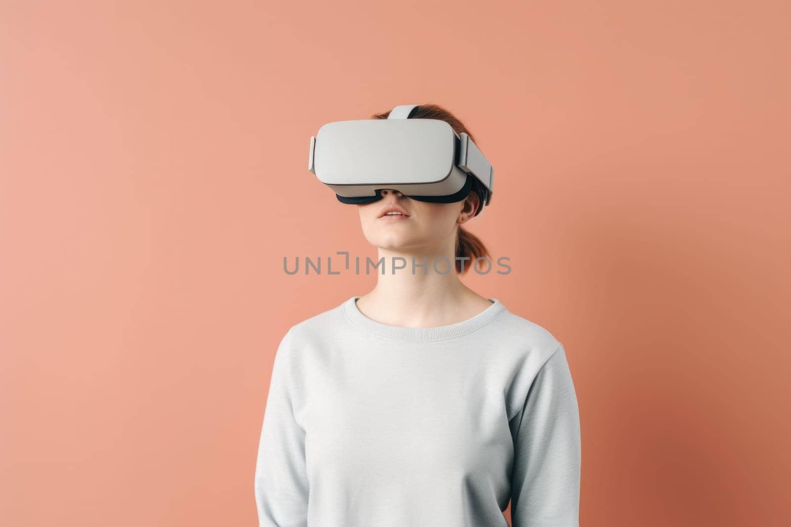 A woman wearing a virtual reality headset against a pink background