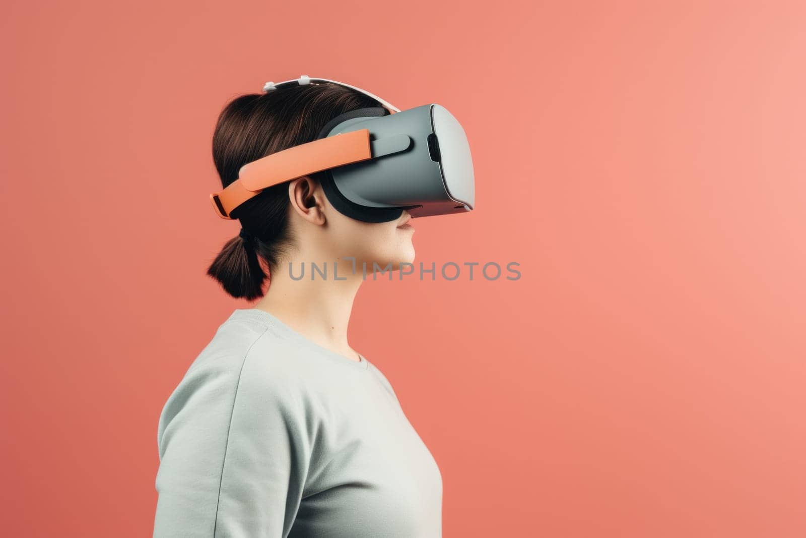 A woman wearing a virtual reality headset against a pink background