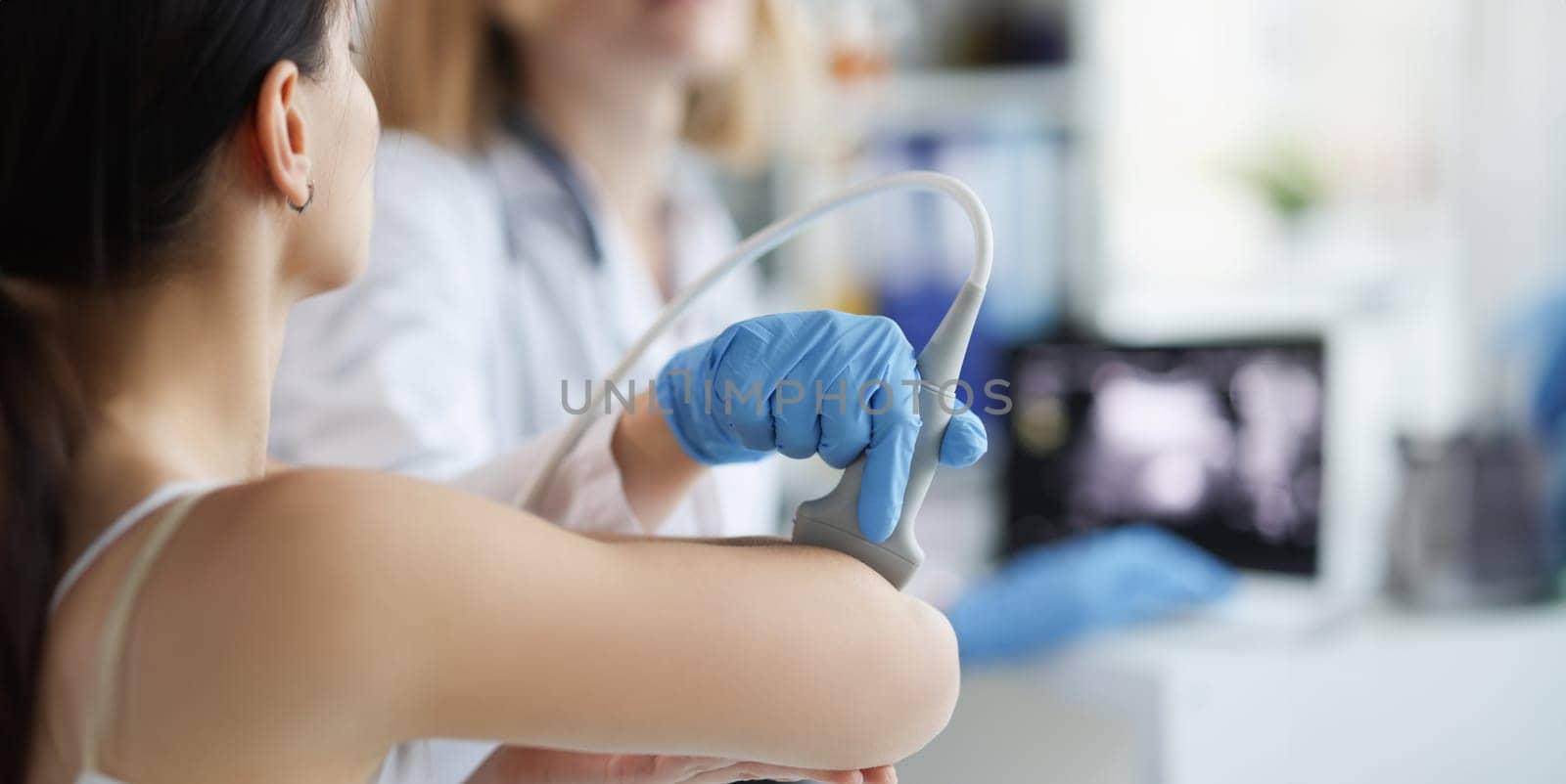 Doctor makes an ultrasound of the vessels of the hands by kuprevich