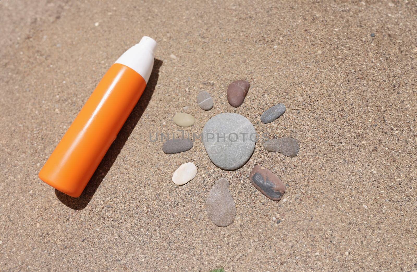 The sun from the stones on the sand, close-up. Wallpaper concept sunscreen cosmetics, summer advertising