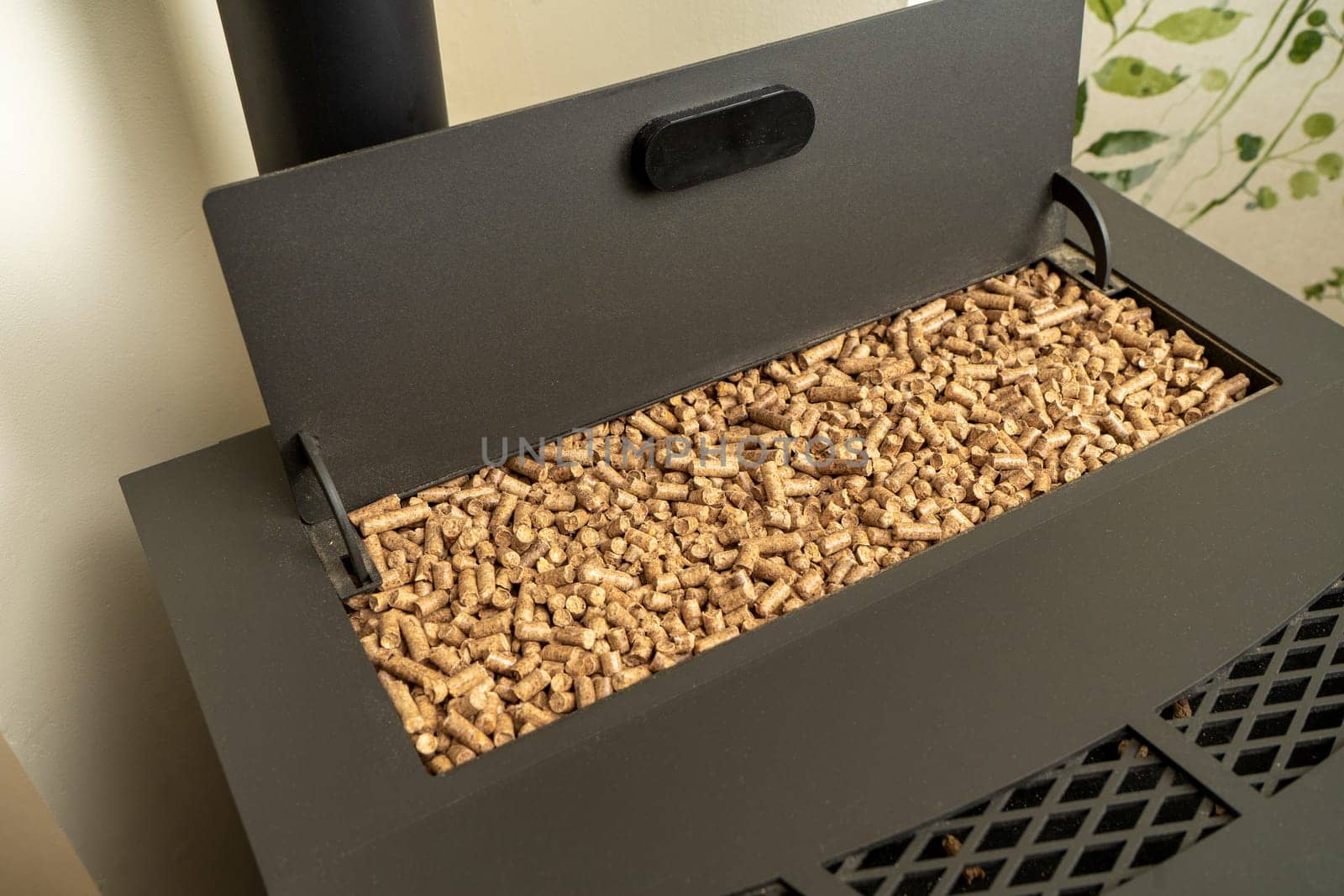 Image of a pellet stove with the hopper filled to the brim with ecological fuel, sustainable and renewable heat