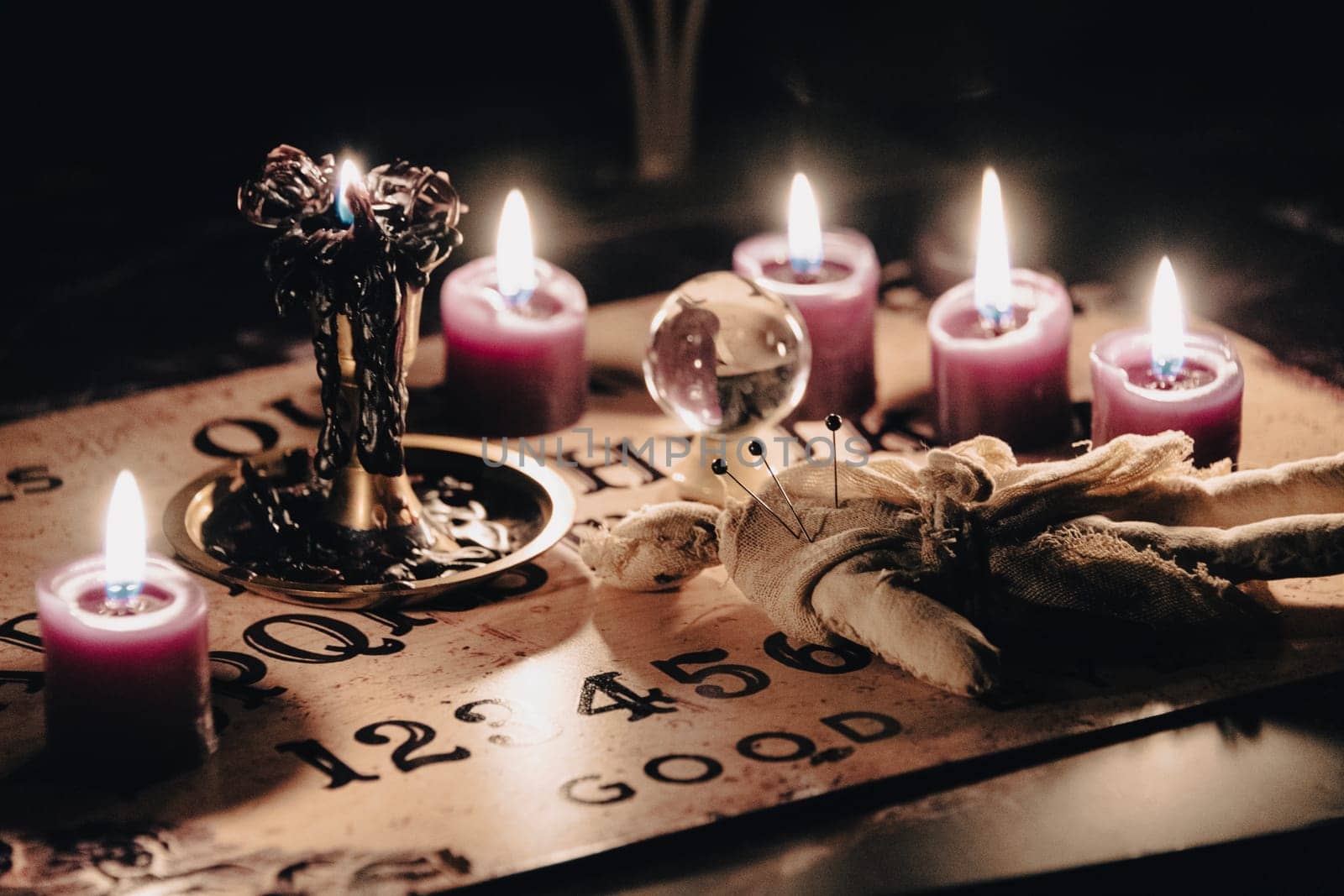 A mystical scene with a crystal ball surrounded by candles, suggesting fortune telling or a séance