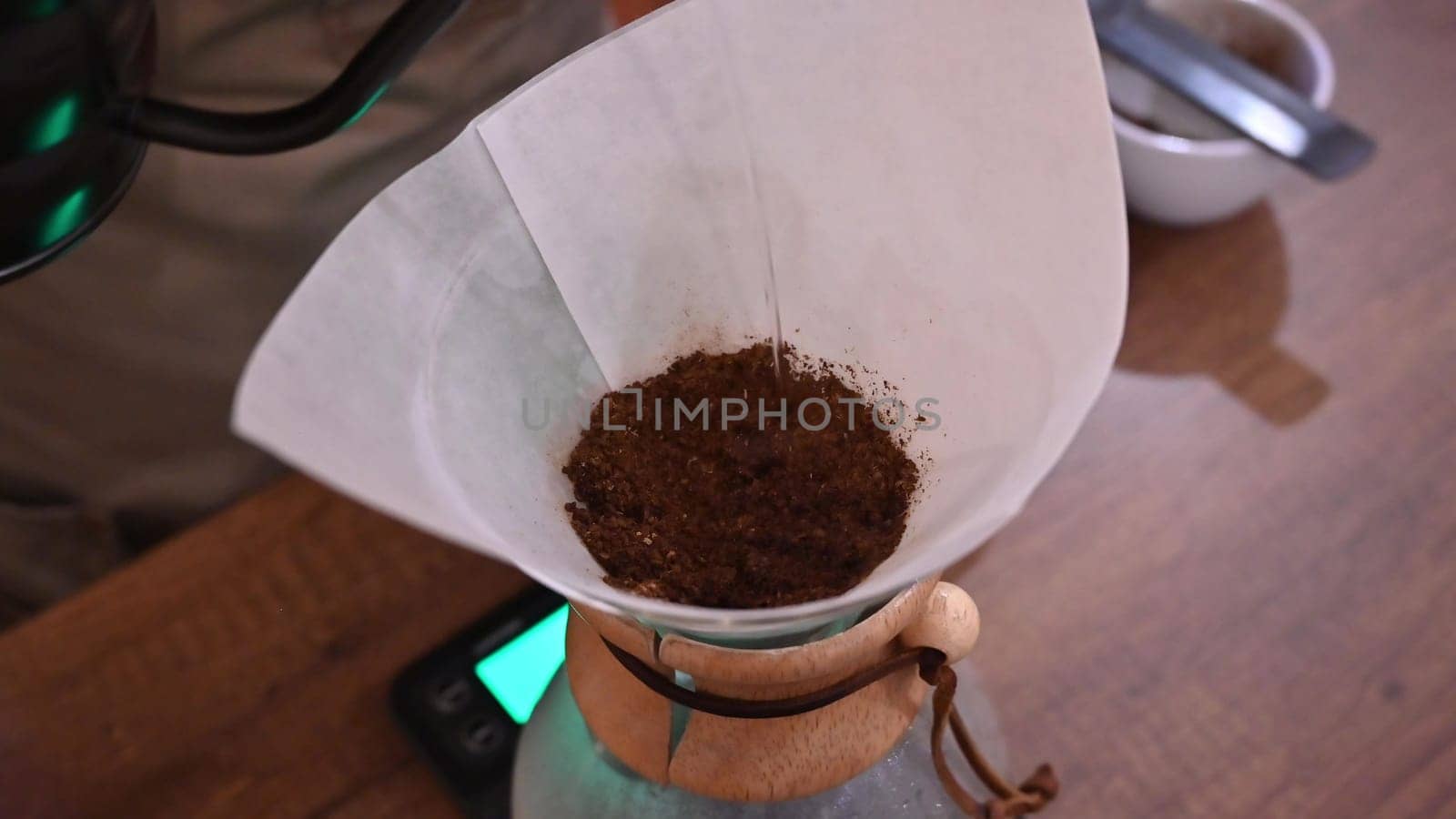 Barista pours water into the filter with coffee, brewing coffee. Alternative coffee-making methods. by Peruphotoart