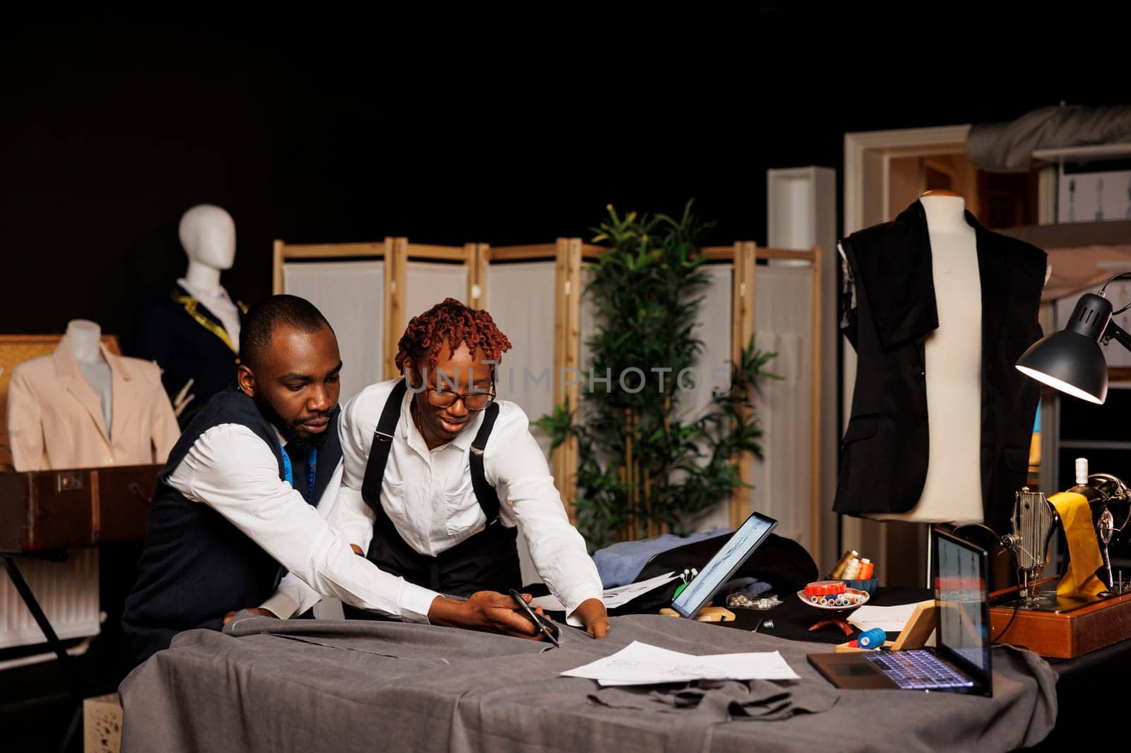 Suitmakers in studio designing clothes by DCStudio