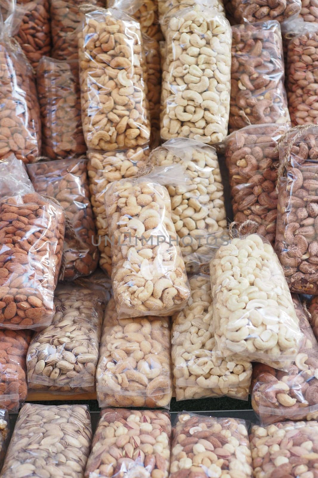 many mixed nuts in a plastic packet on shelf by towfiq007