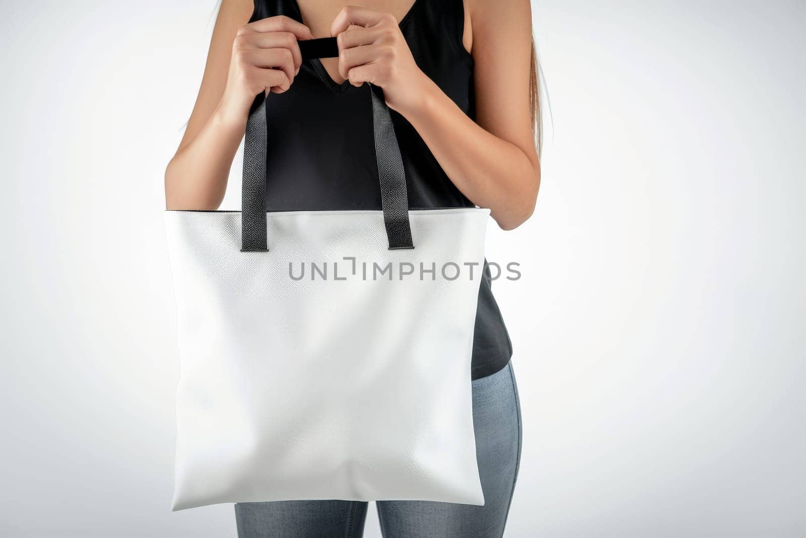 woman Hand holding a White Polyester square tote bag for mockup . AI generated image by matamnad