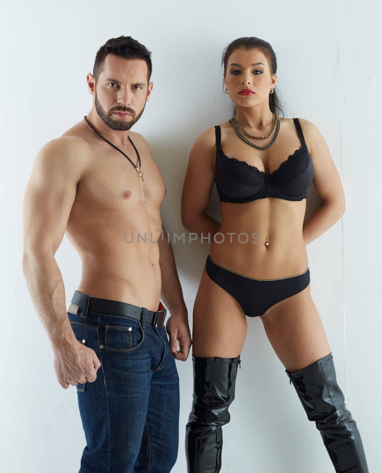 Strength and passion. Handsome man with busty woman, on gray background