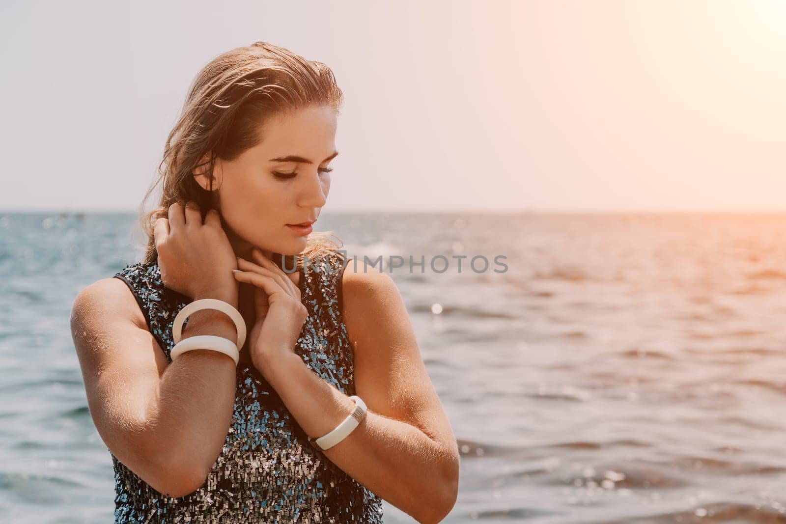 Woman summer travel sea. Happy tourist enjoy taking picture outdoors for memories. Woman traveler posing on the beach at sea surrounded by volcanic mountains, sharing travel adventure journey by panophotograph