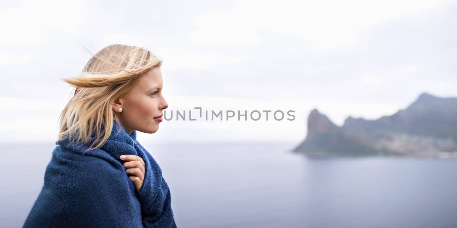 Thinking, ocean and woman with blanket in nature for adventure on holiday, vacation and weekend outdoors. Mountain, travel and person by seaside for relaxing, happiness and peace in countryside by YuriArcurs