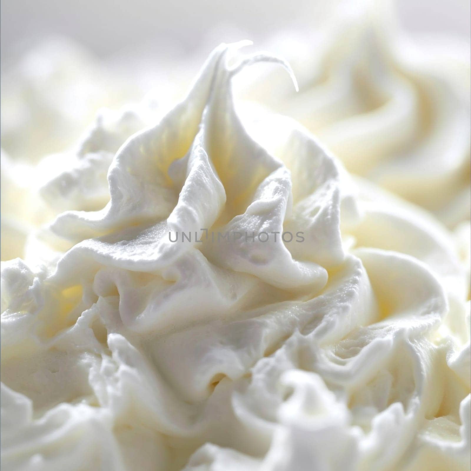 A close up of a bowl full of whipped cream with some swirls