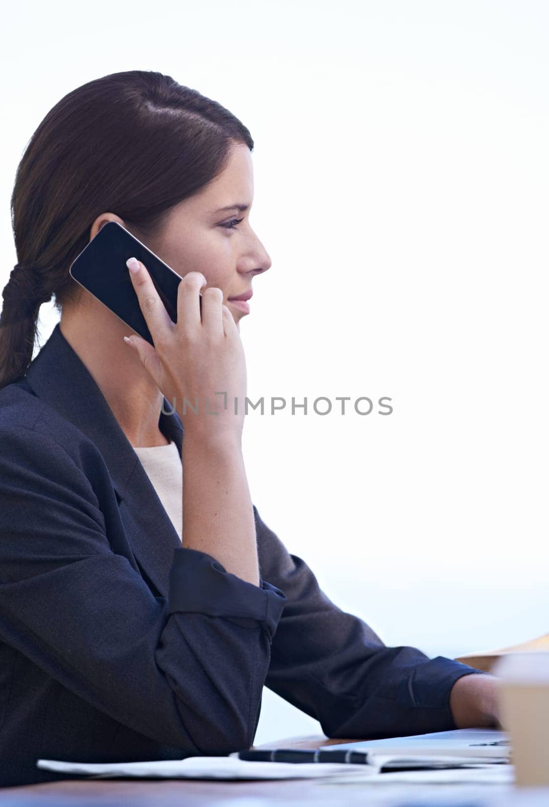 Professional woman, talking and phone call at work with white background, communication and networking. Profile, conversation for finance of business, employee and worker in corporate company.