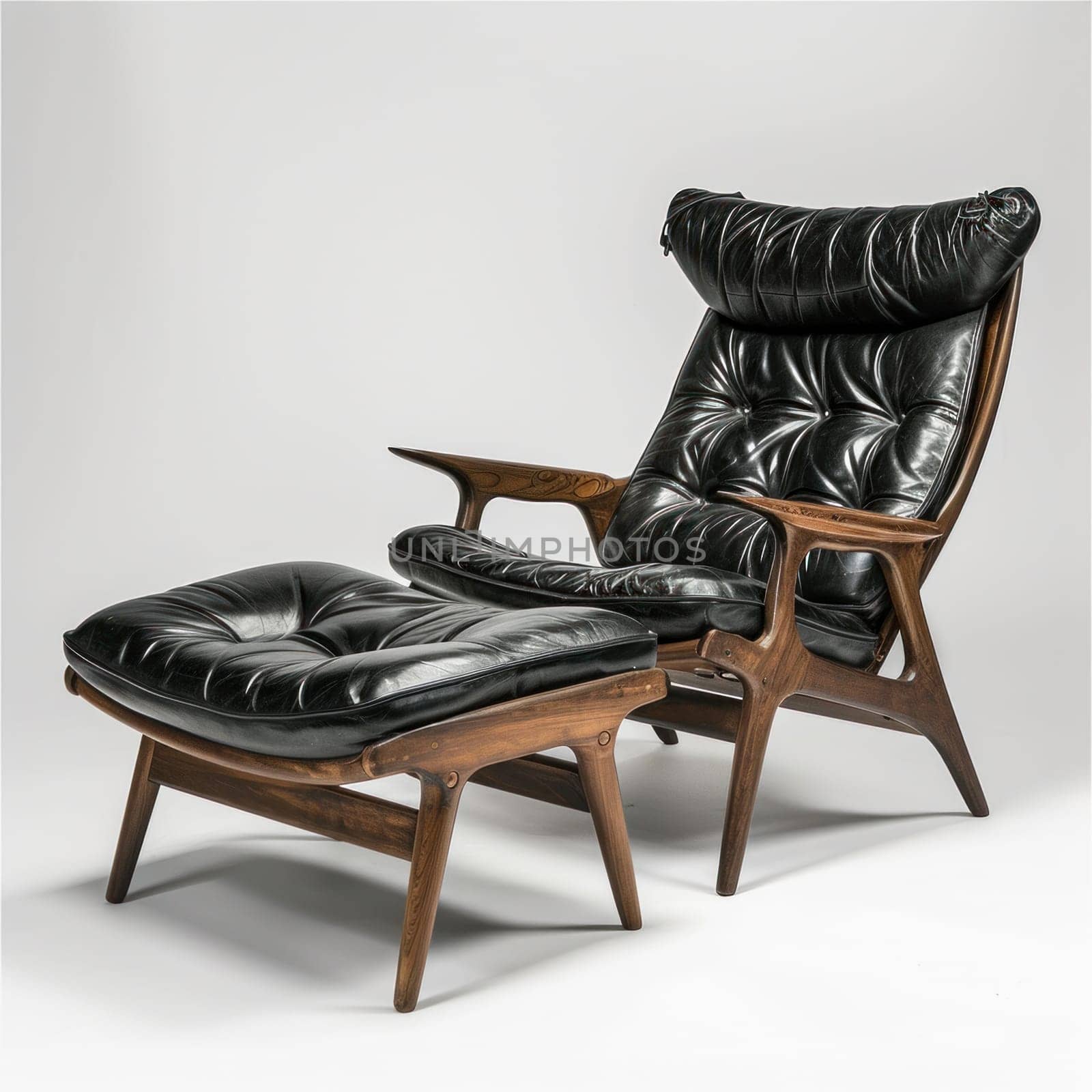 A black leather chair and ottoman with a wooden frame