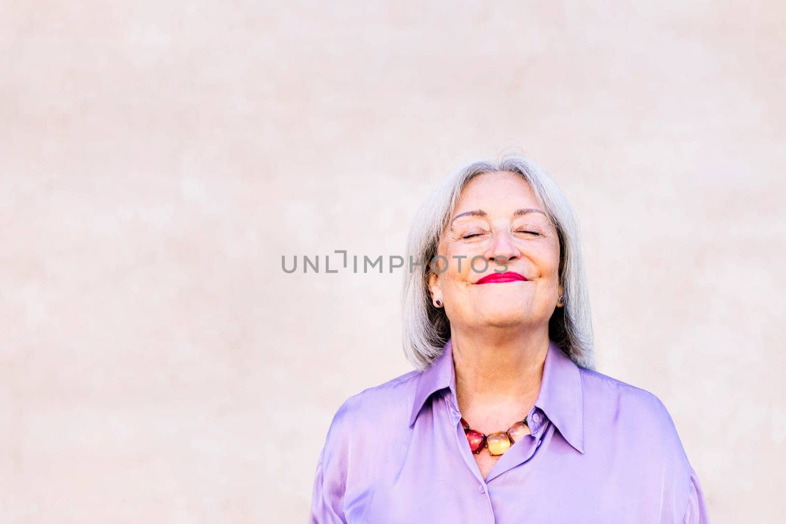 nice senior woman smiling with eyes closed by raulmelldo